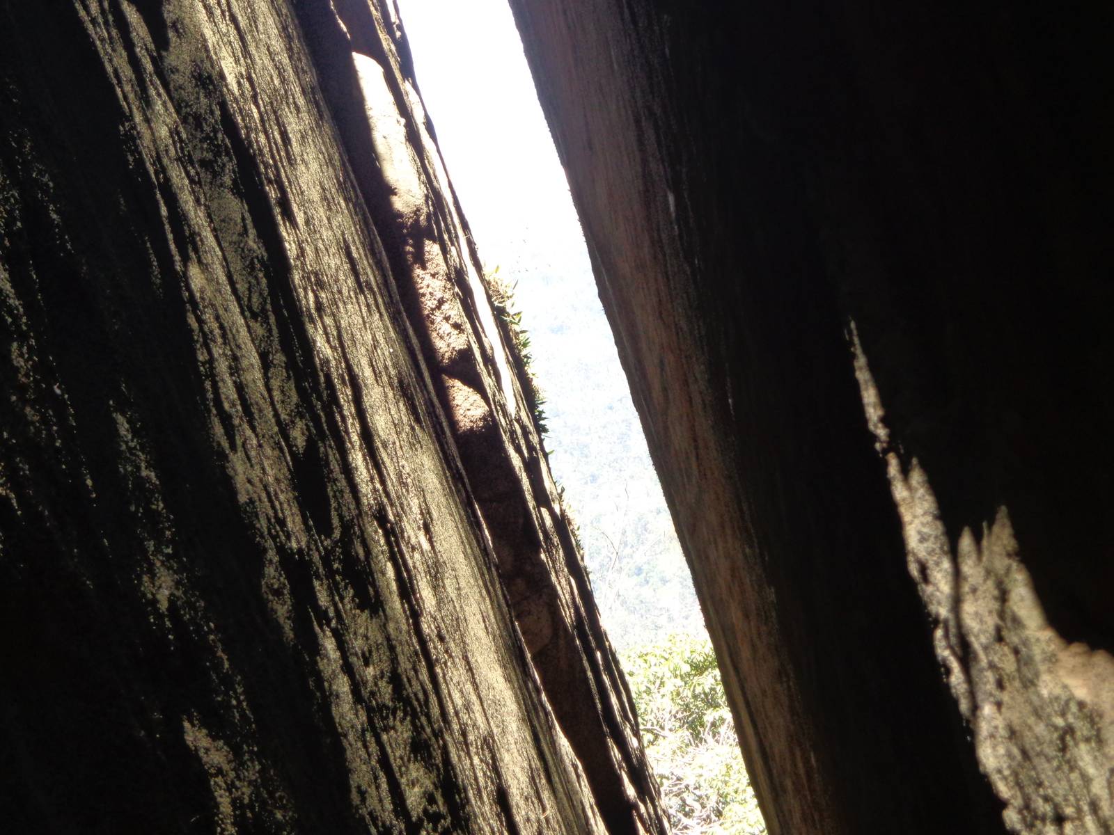 The cave is technically not a cave but a shelter formed by a few hanging rocks between two separate hills. This is the gap between them.