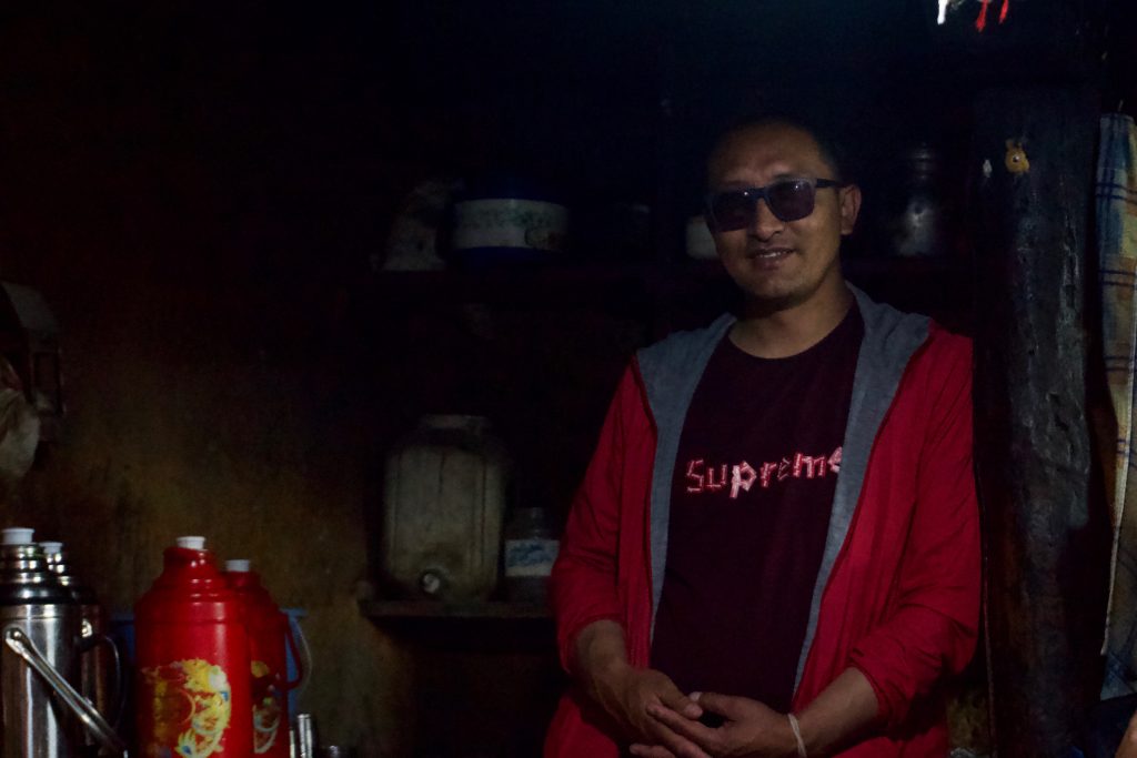 Gyala Lama with flasks filled with tea.