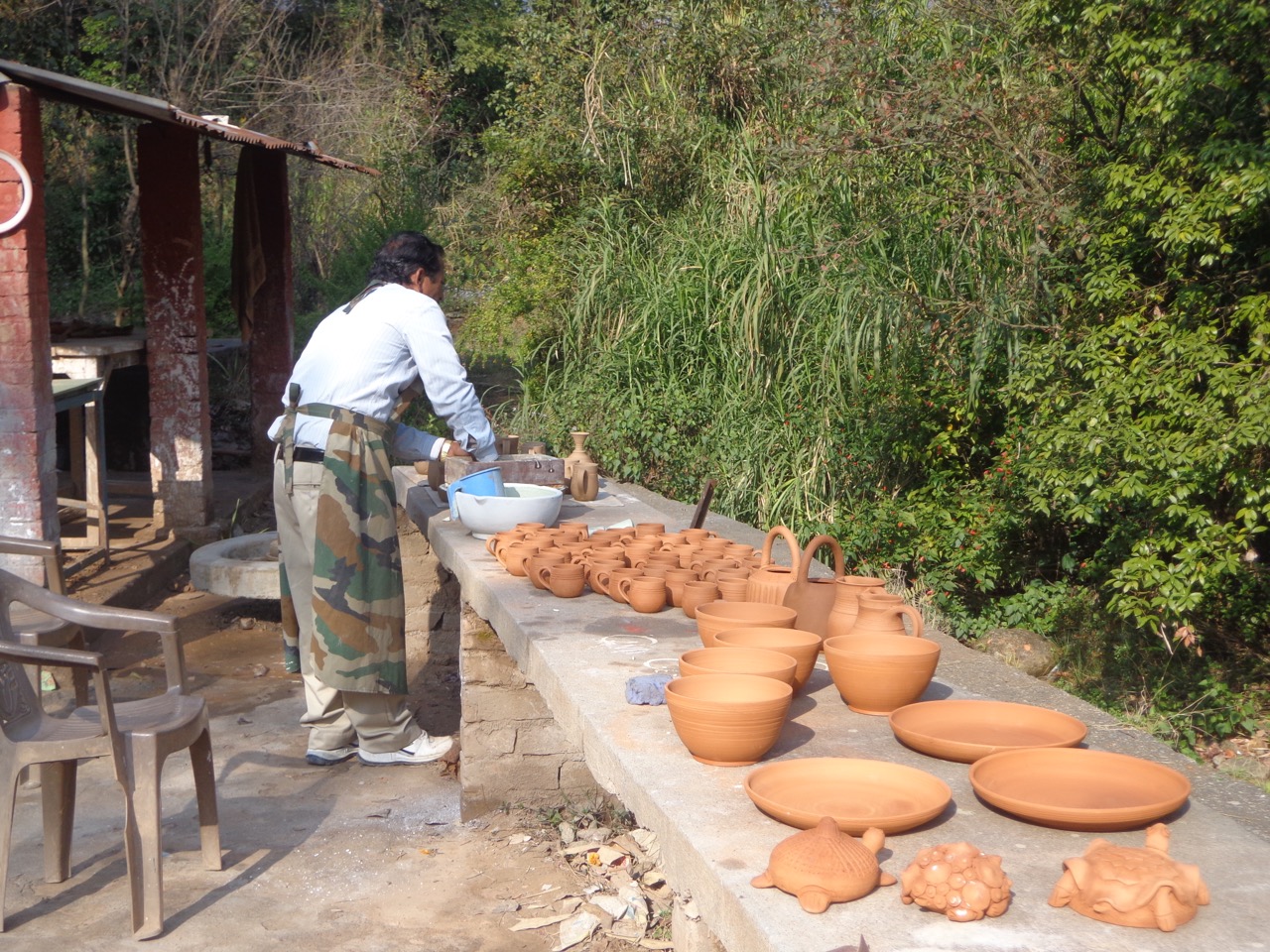 A potter mixing colours for designs on clay.