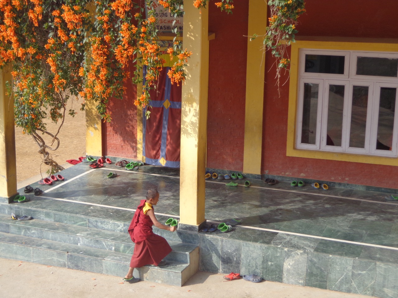 A young monk entering the Tashi Jong School.