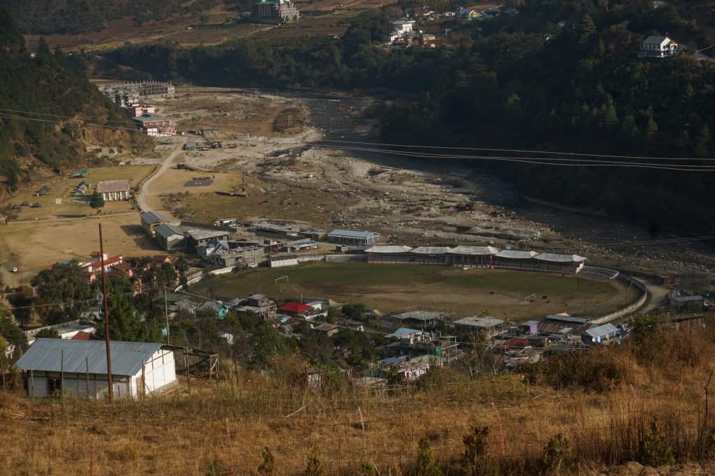 Lopon Stadium in Dirang—where football tournaments are held—as viewed from the monastery grounds. There were posters and banners about an upcoming tournament in the market.