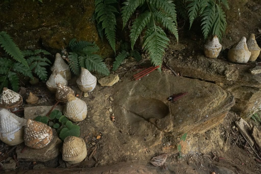 The locals worshiped this footprint of a lama who was related to the first Dalai Lama. The small stupas are made in memory of the deceased.