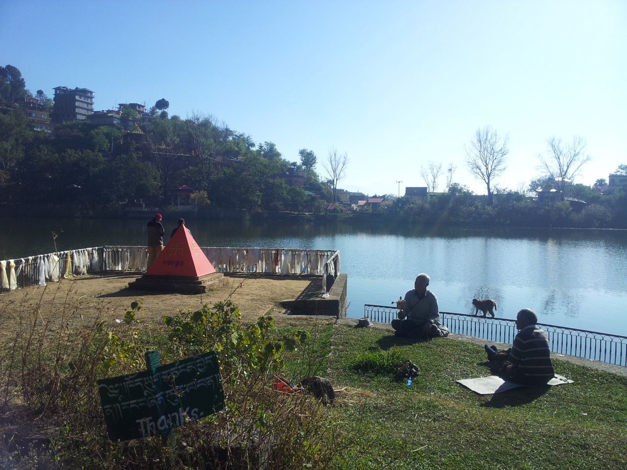 Old Buddhist men rotating their prayer wheels.