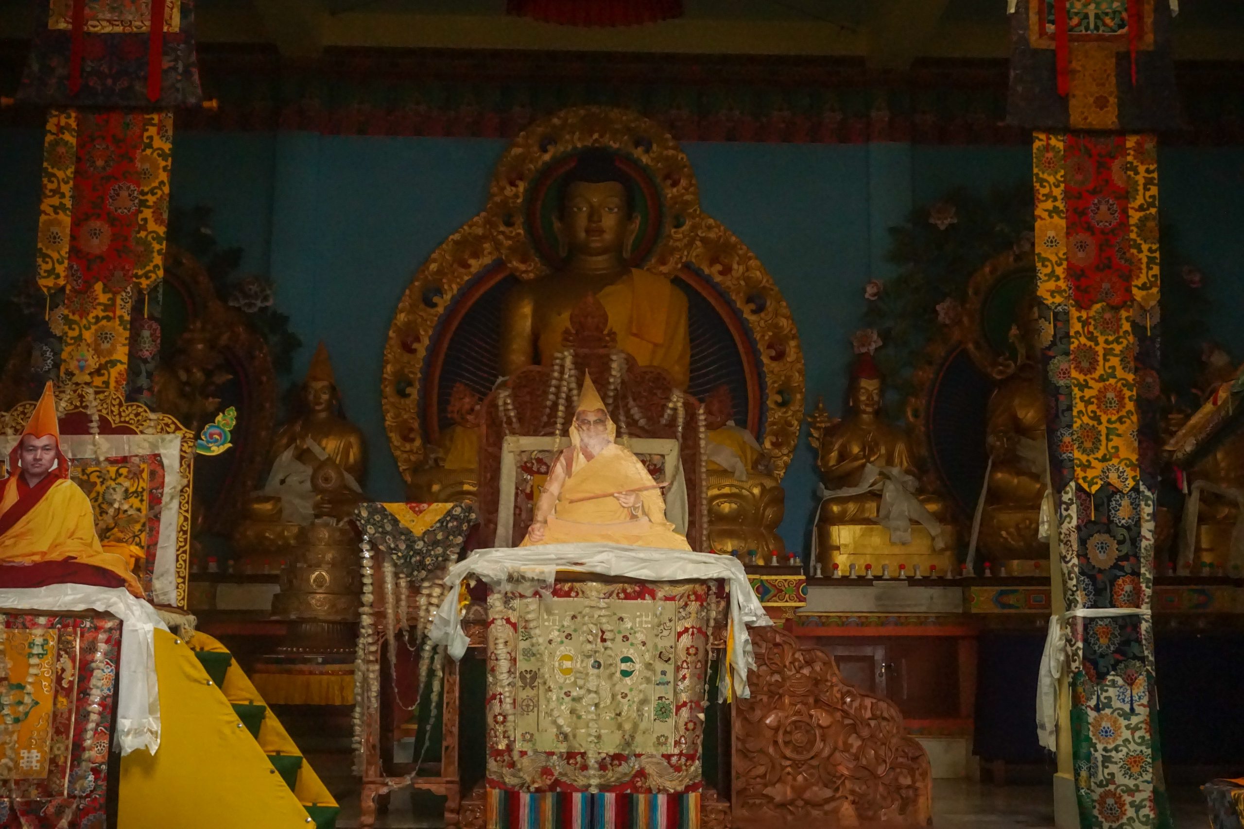 Buddha Statue and the current Dalai Lama&rsquo;s cutout in the prayer hall.
