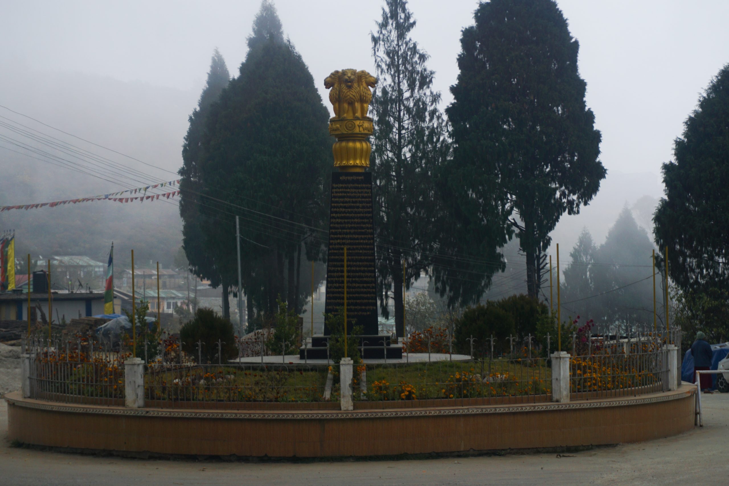An Ashoka pillar near the entrance of the monastery. The inscription recounts the destruction of 1962 and wishes for peace.