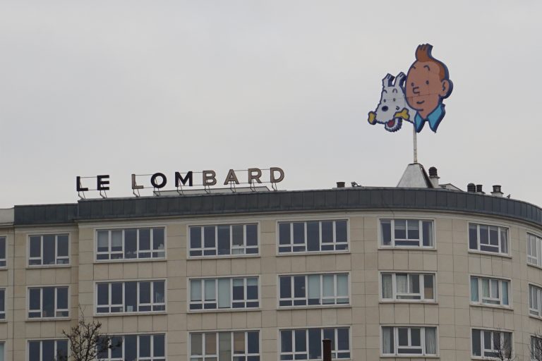 There is a Tintin sign visible right outside at Brussels-Midi station.
