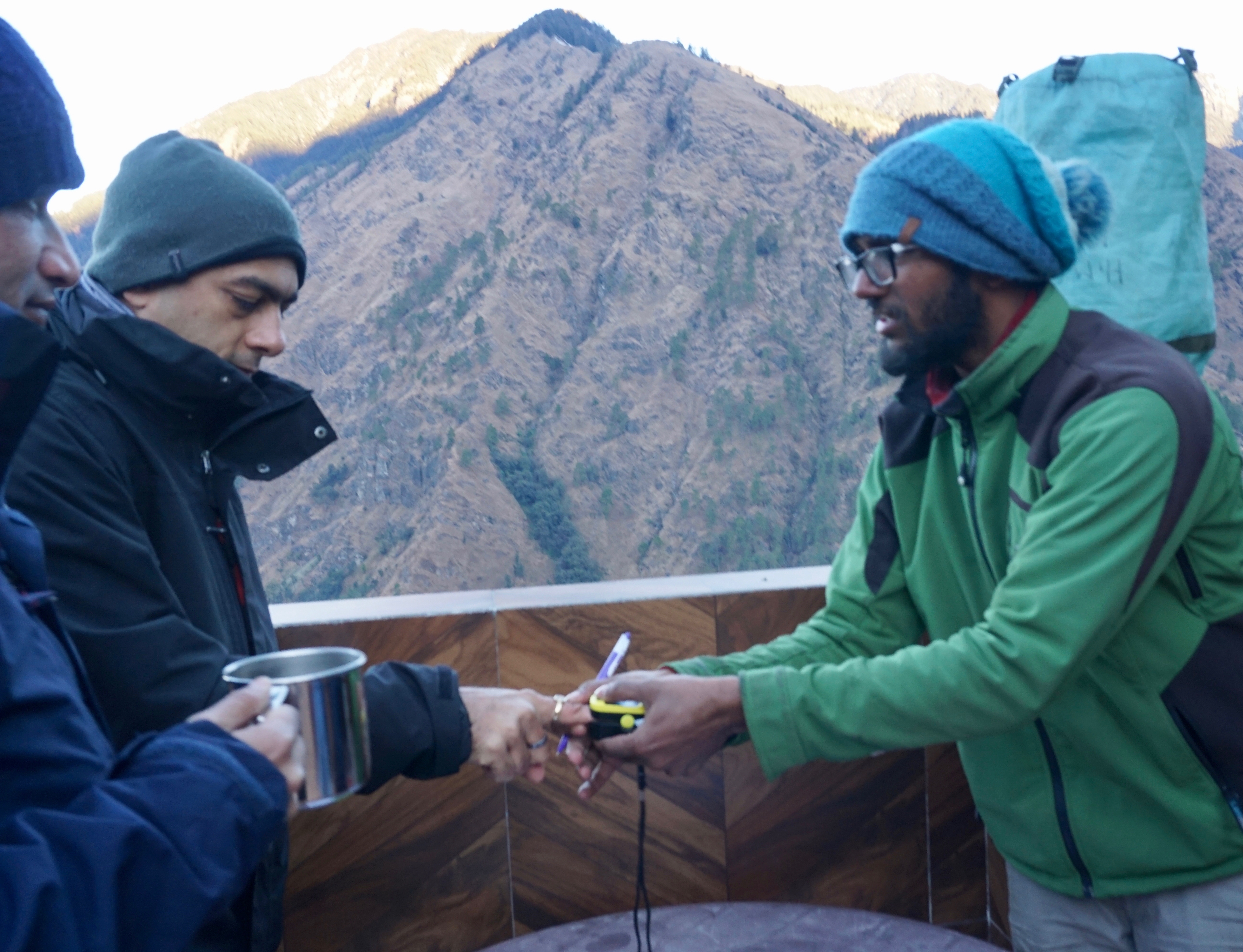Karthik taking pulse and oxymetre reading of Siddharth, a fellow trekker. These readings, taken thrice a day, were recorded in health cards.