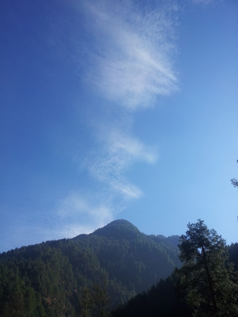 The clouds made an interesting pattern in the sky. As if, the mountain was a chimney.