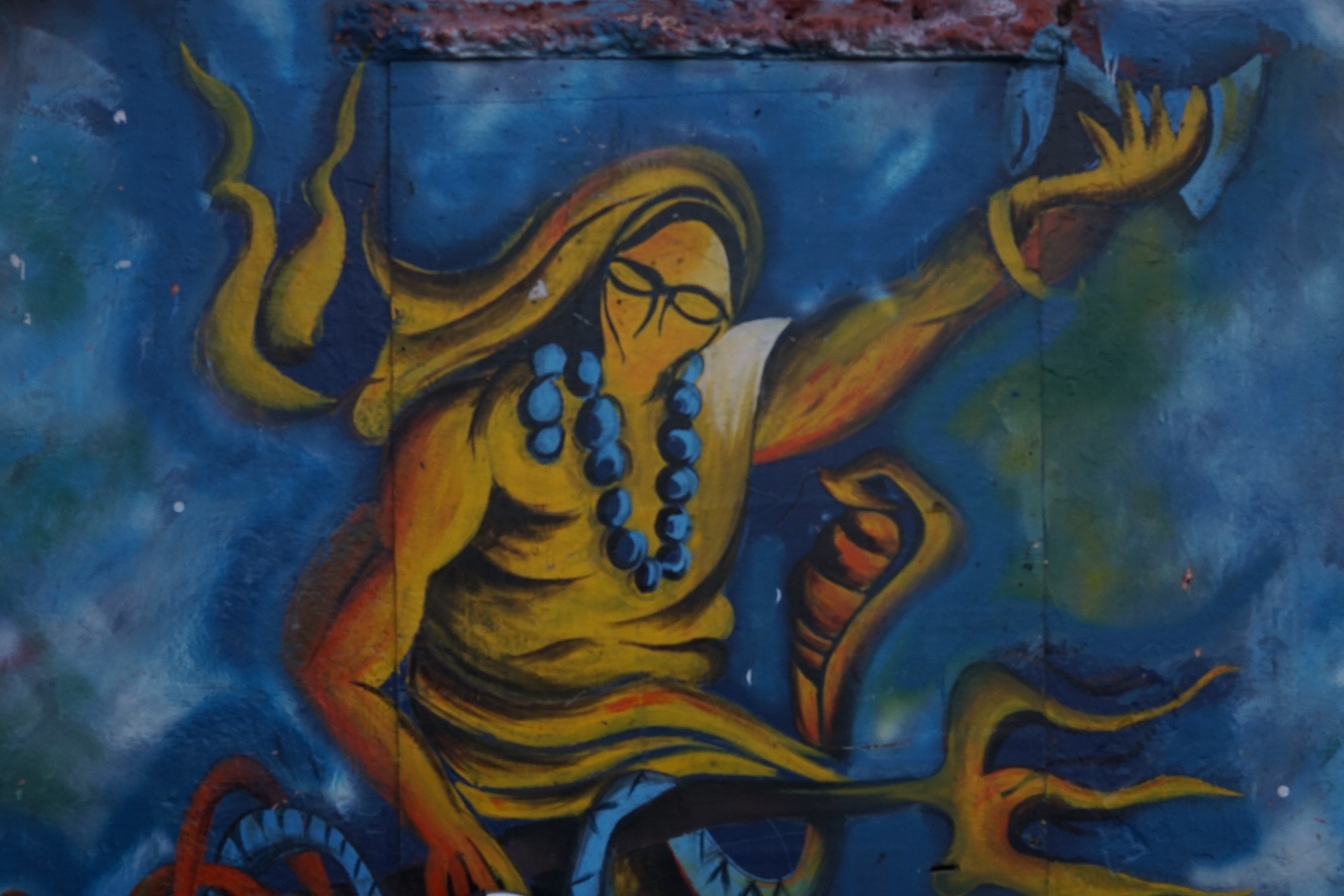 A modern, reductionist painting of Shiva on one of the walls at Haridwar.