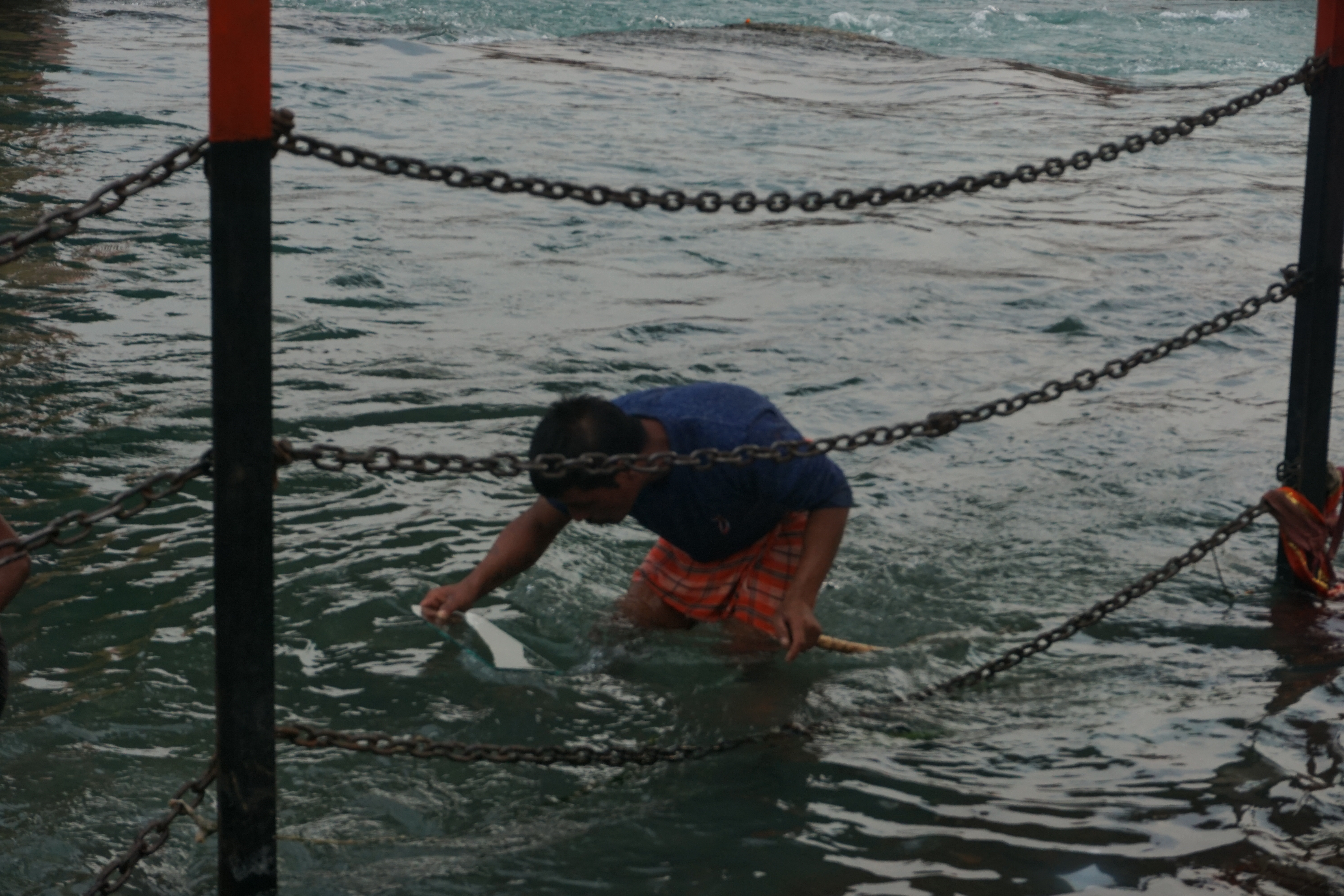 A lot of guys search for coins in the using a piece of glass and a magnet at the end of a stick.