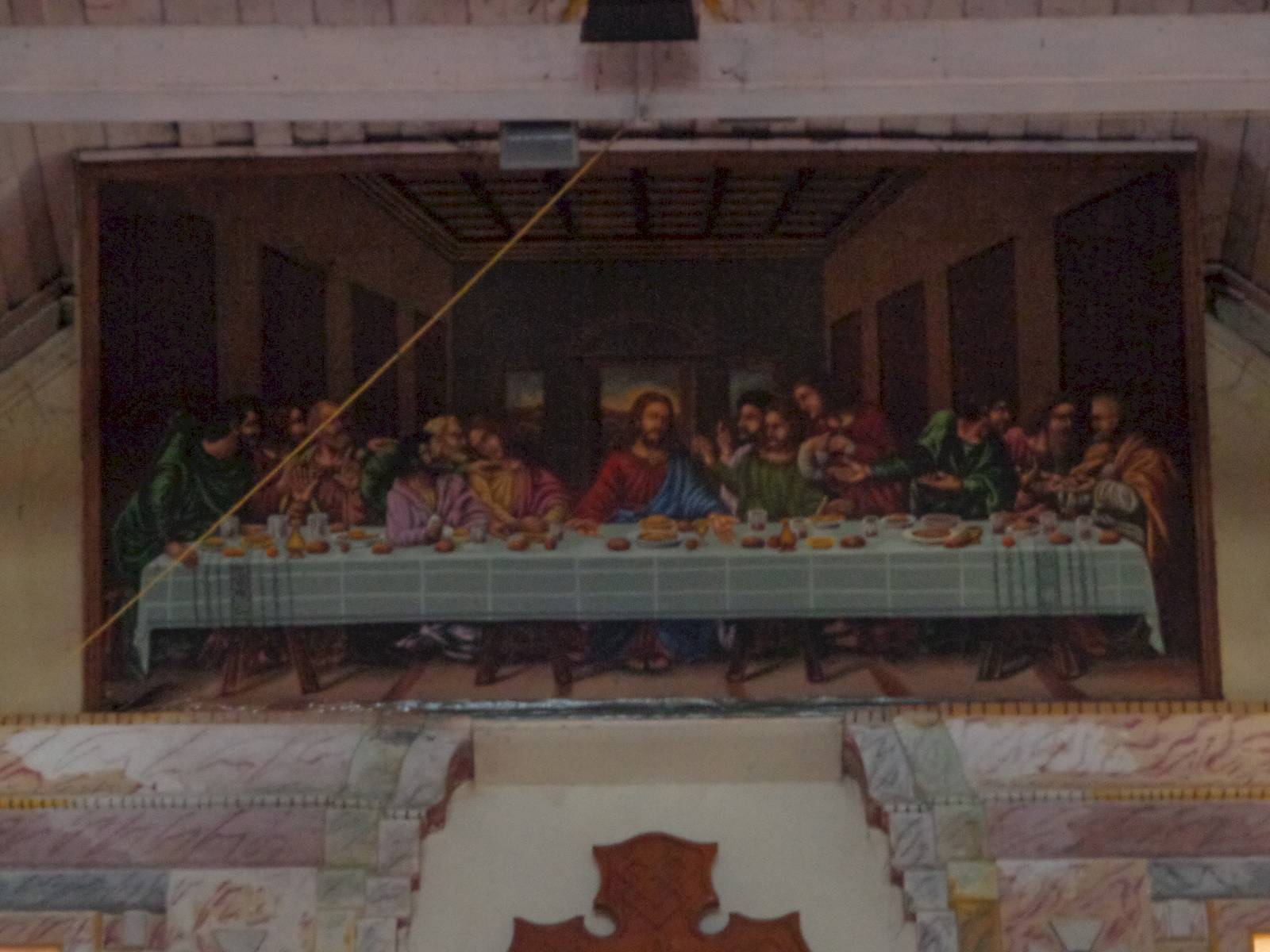 A depiction of The Last Supper was painted high up on the wall behind the alter.