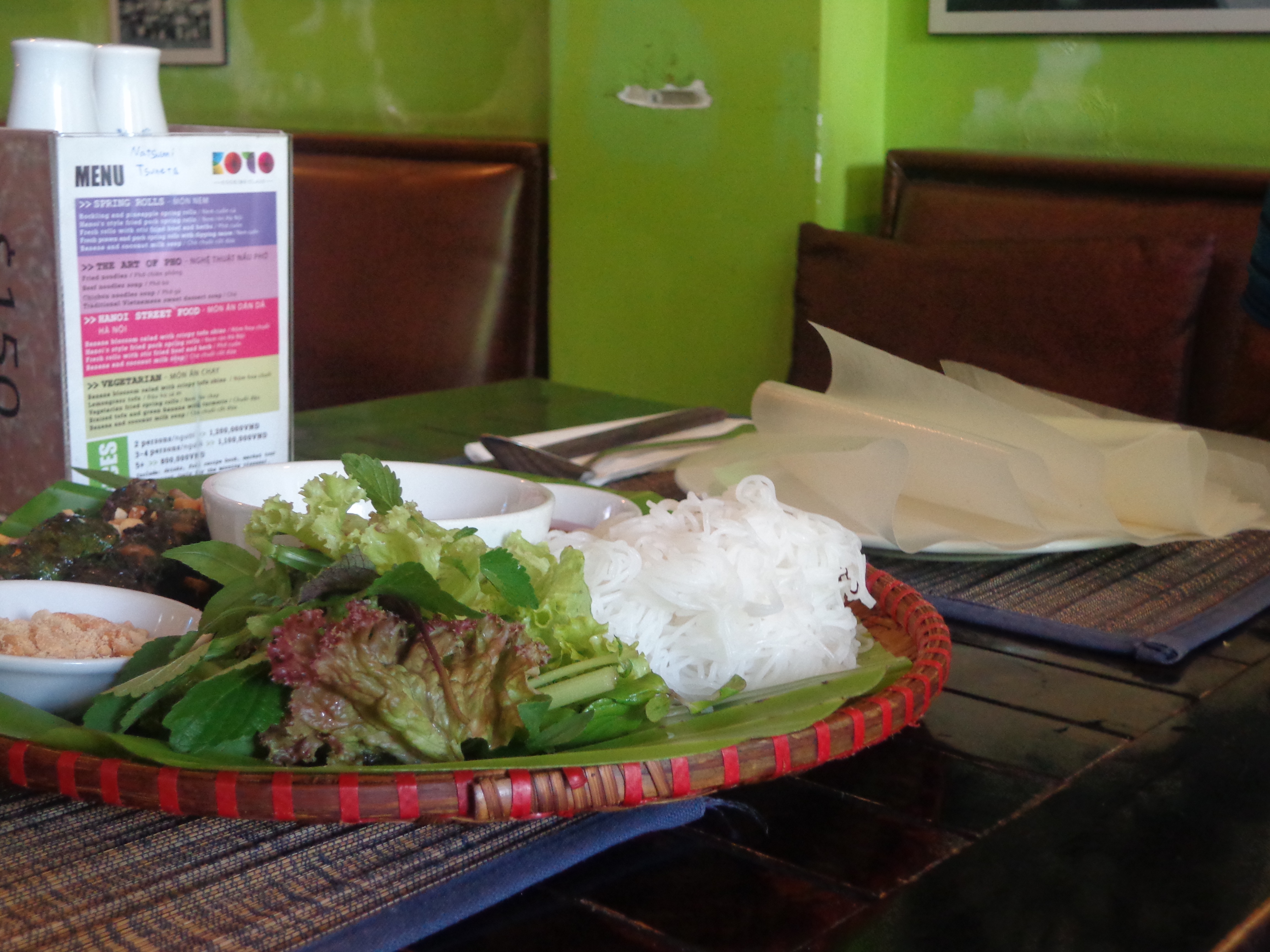 This is a deconstructed Vietnamese roll. Rice paper is provided along with cooked ingredients. One must wrap the ingredients to make a roll, dip it in the condiment and bite in.