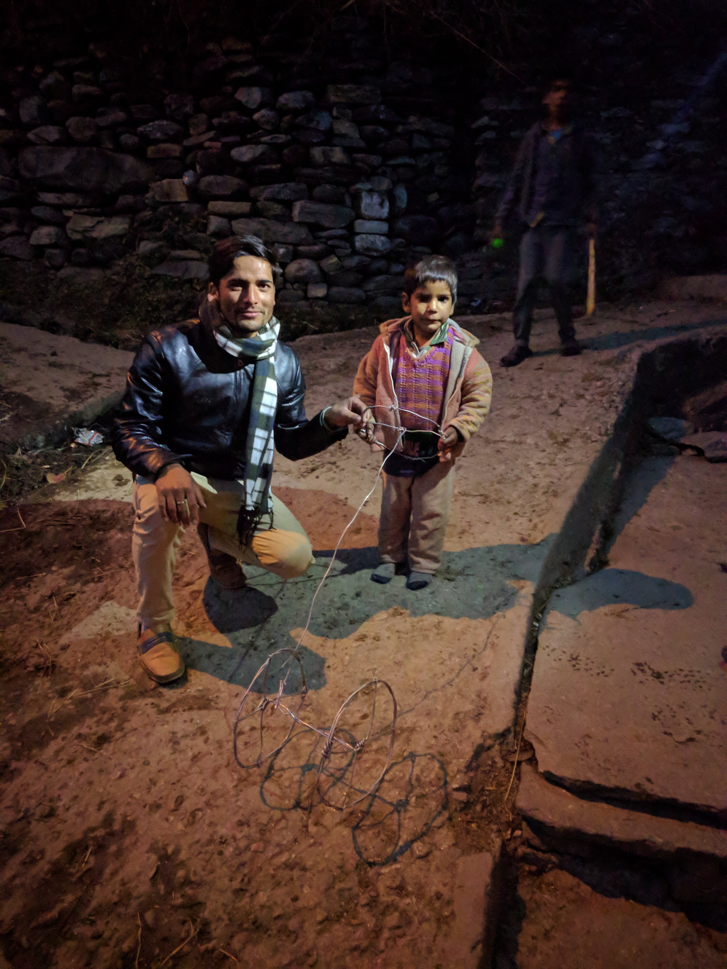 Mahavir with a village kid and his play-thingy.
