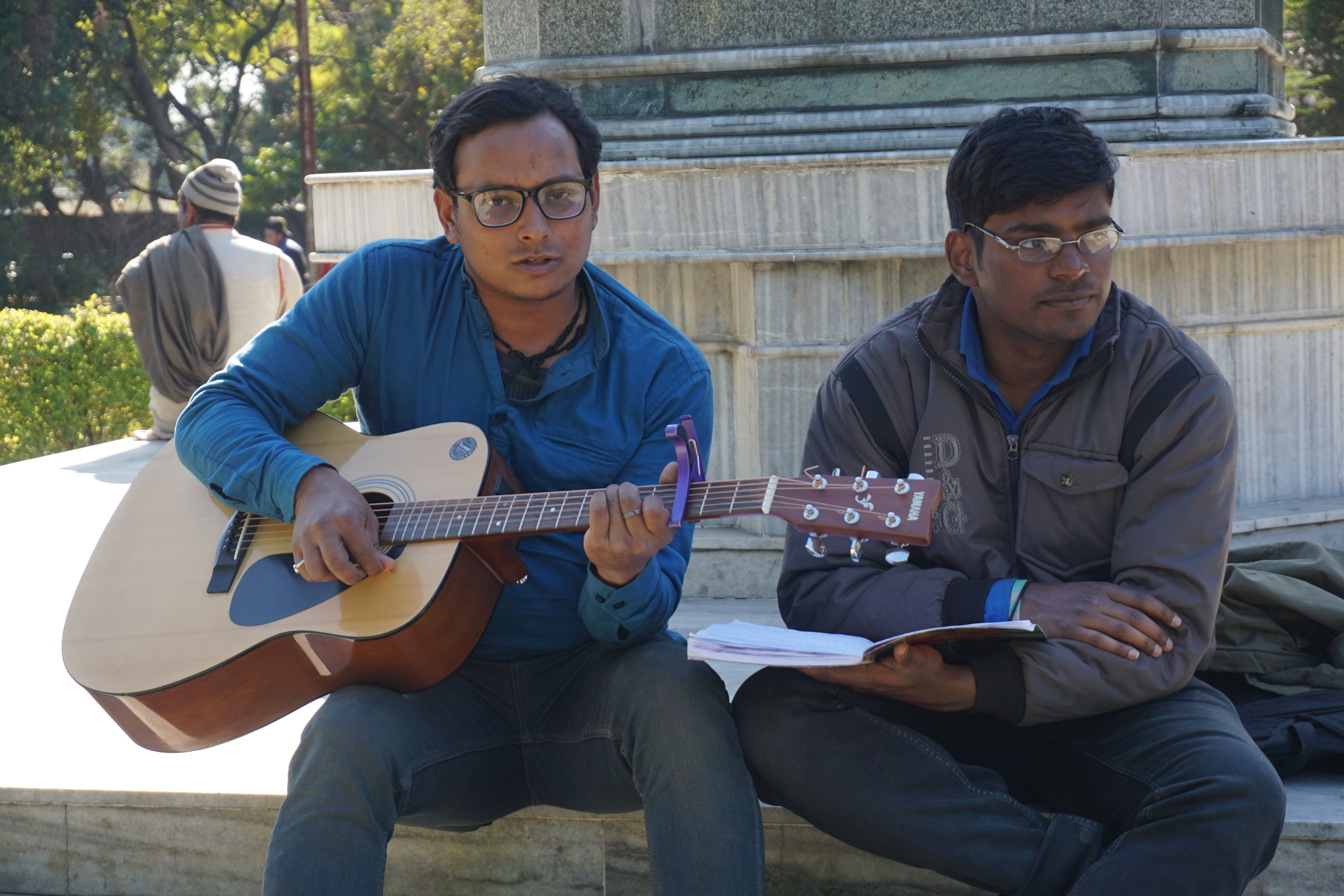 Deepak Topal sang while strumming his guitar. His elder brother owned a small recording studio.