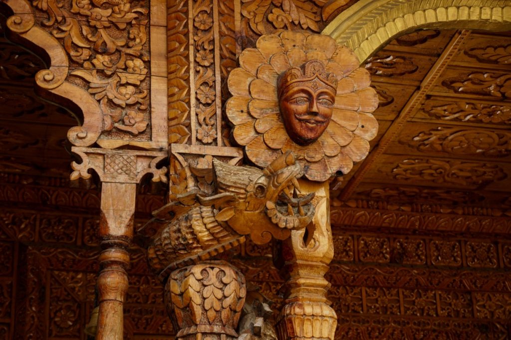 The woodwork in the temple had a lot of Tibetan influences. The facemask has elements of style that have been clear resemblance to the Tibetan monastery wall paintings. The dragon is not a symbol that is native to Hinduism.