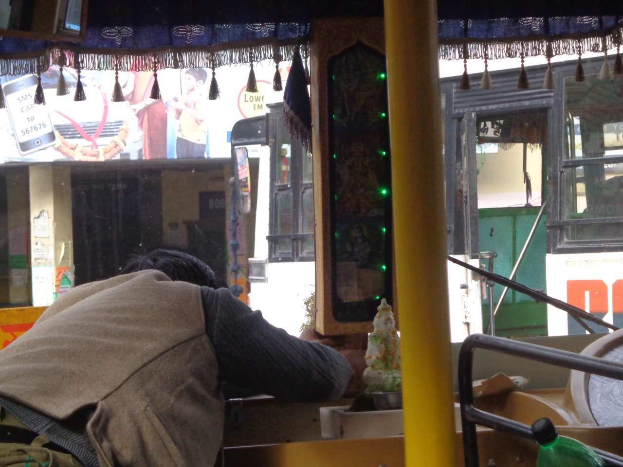 Before starting the journey, the driver offers, or rather shoves into a slit, a twenty rupees note to the deity.