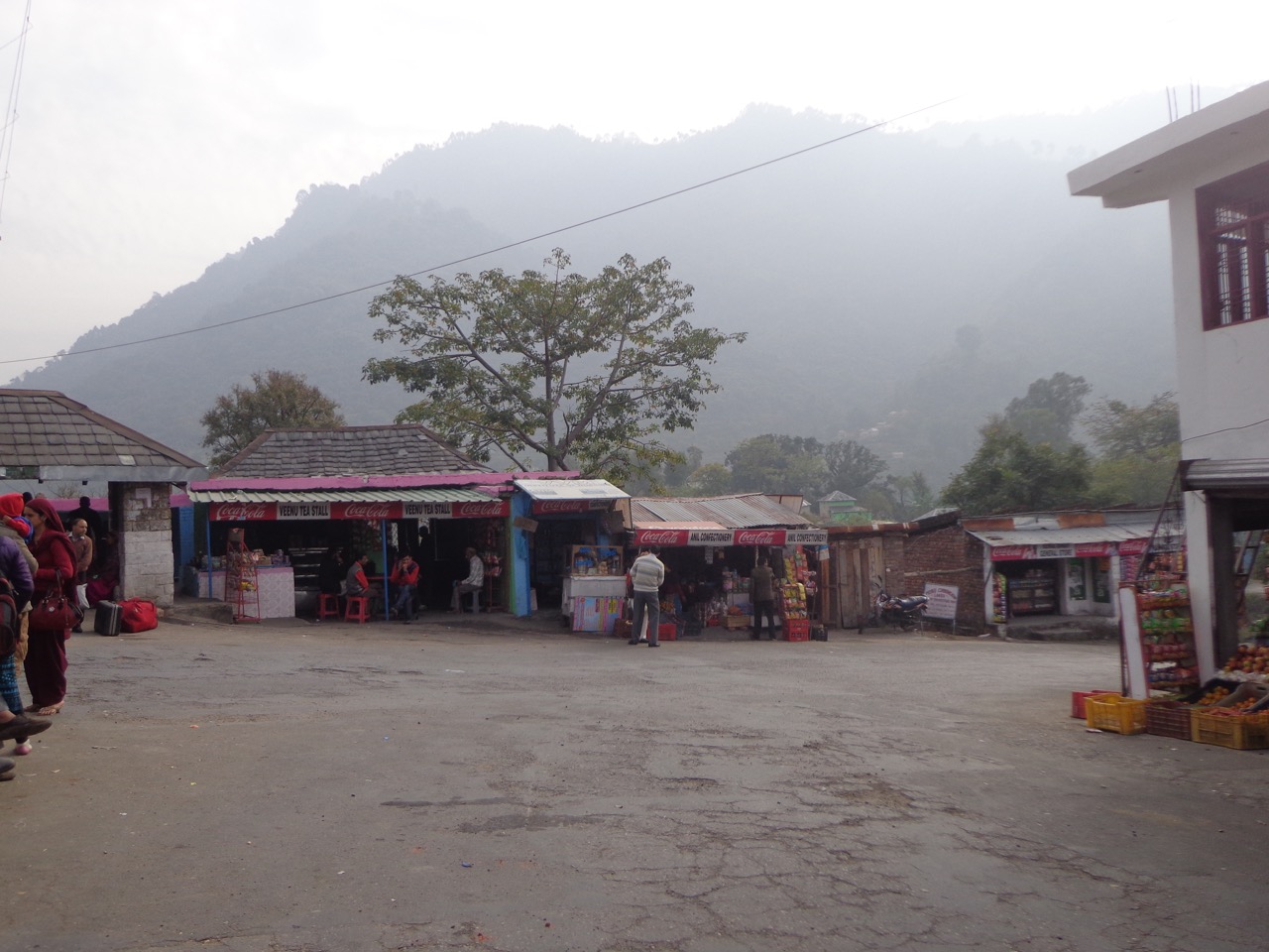 Lahru has only a handful of shops. The foggy mountains make a picturesque background.