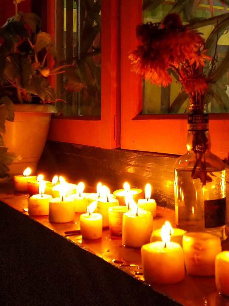 Candles and flowers on the windosills of the Gompa.