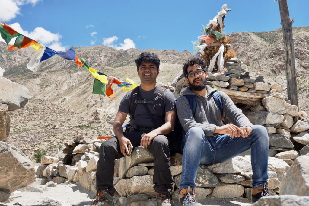 Me an Sai sitting on the stupa near the large prayer wheel.