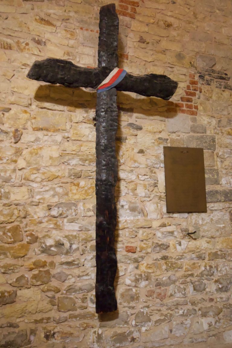 A cross made from charred wood left behind by the Nazis before the liberation of Prague in 1945. It is a remembrance to those who had died in the town hall when the Nazis set it on fire before fleeing.