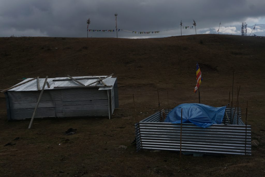 I crossed these makeshift shelters in an otherwise barren meadow. The one on the right has a a camping tent underneath the plastic sheet. There was also a wristwatch on the poles that supported the corrugated sheets indicating that it was inhabited.
