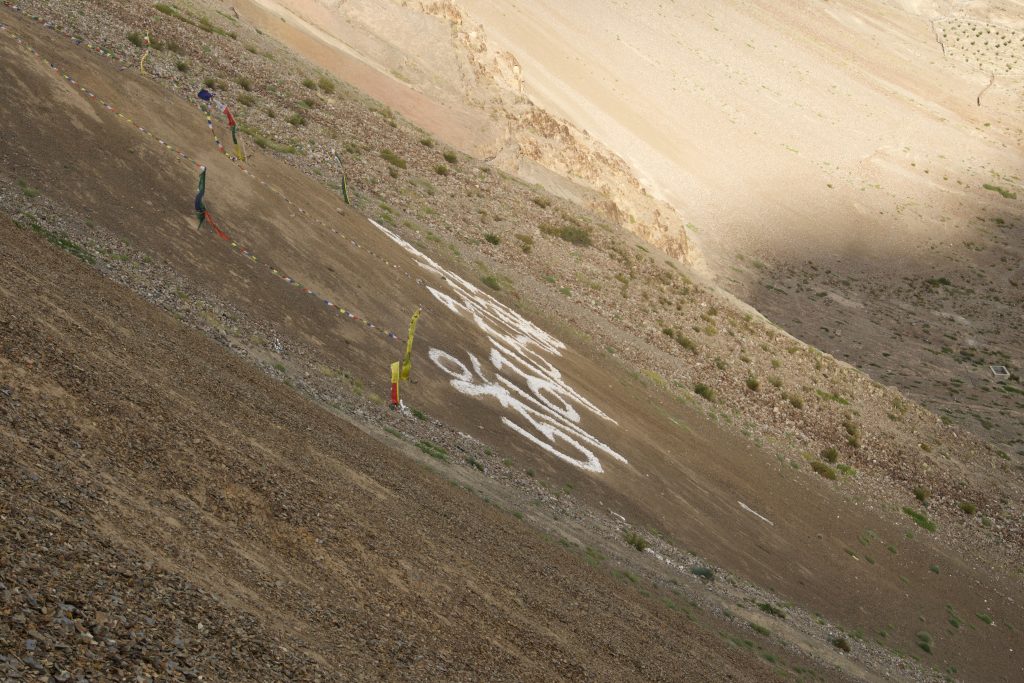 I am still baffled by how the villagers could write the mantra on a slope that is untraversable.