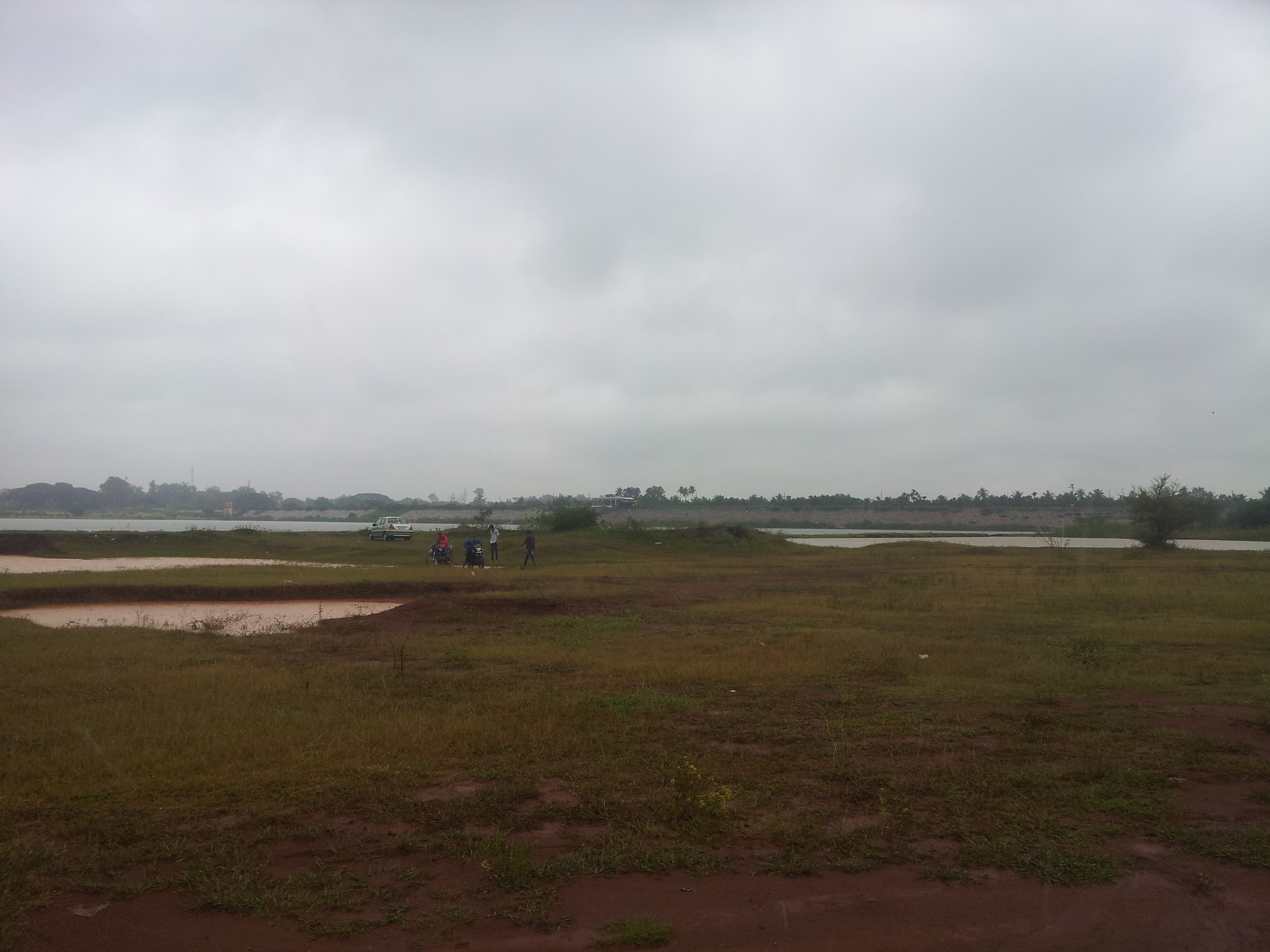 The lake bed from its Western entrance. The college kids in this picture were busy washing sticky clay off their motorbikes.
