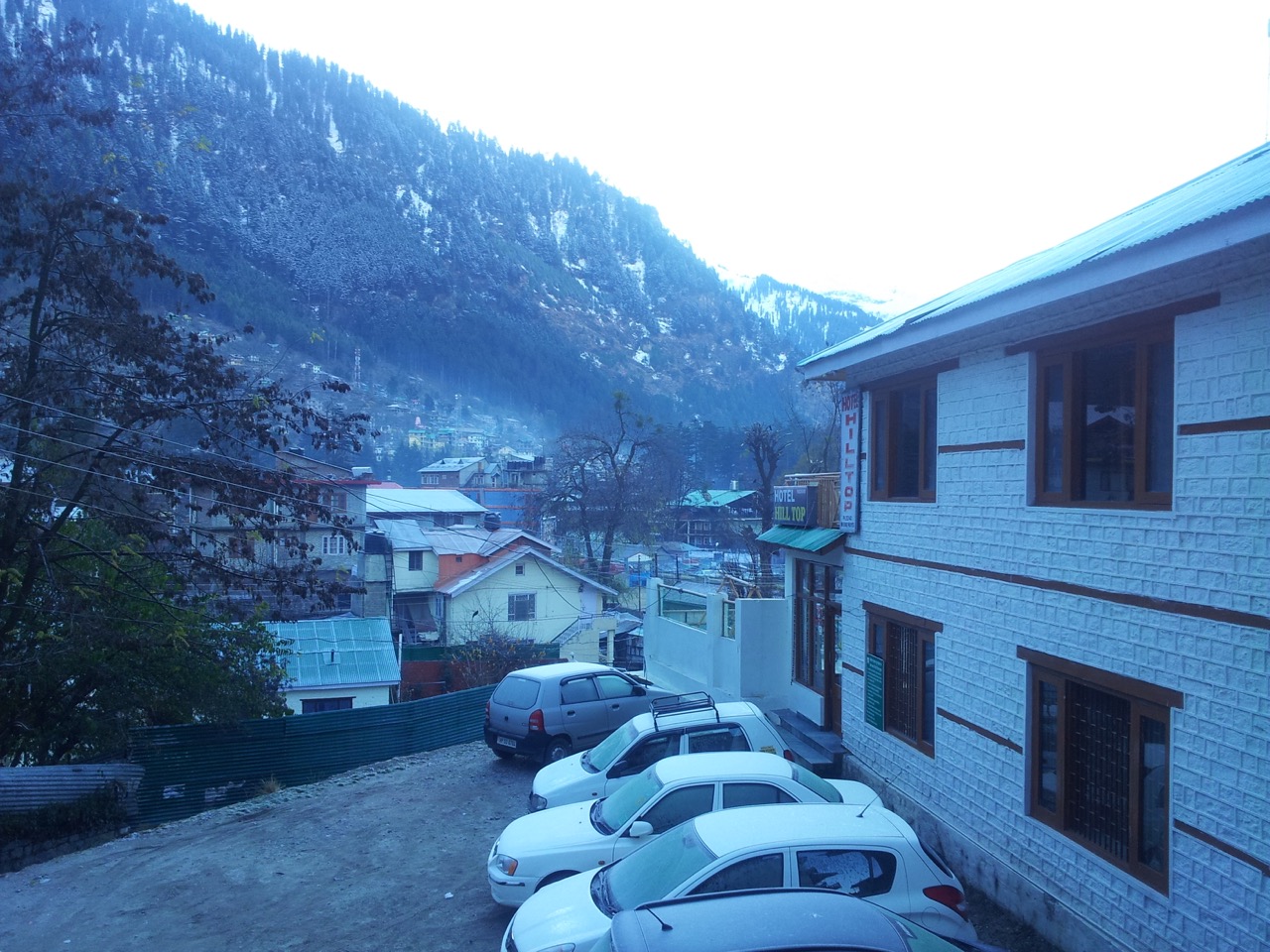 A view from my hotel balcony. A thin layer of snow is visible on the cars’ windows and windshields.