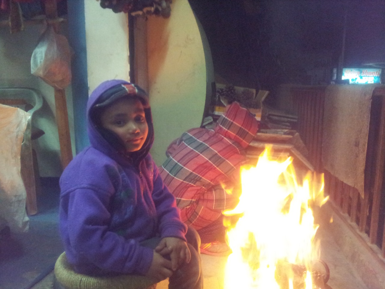 Sushant, the kid of the shopkeeper across my place posing in front of the fire. He studies in first standard and won’t be getting his holidays before 25th of this month.