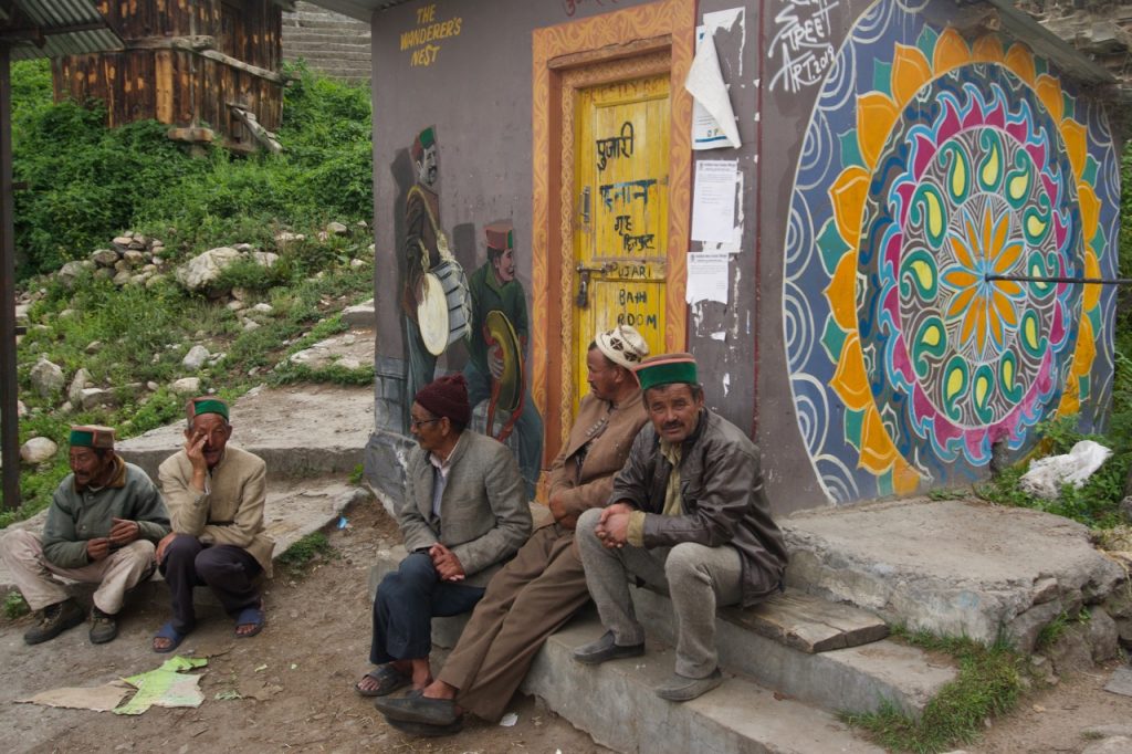 Villagers chatting up near the priest’s bath-house. The Wanderer’s Nest—a hotel in Chitkul—has painted murals over many walls in the village.