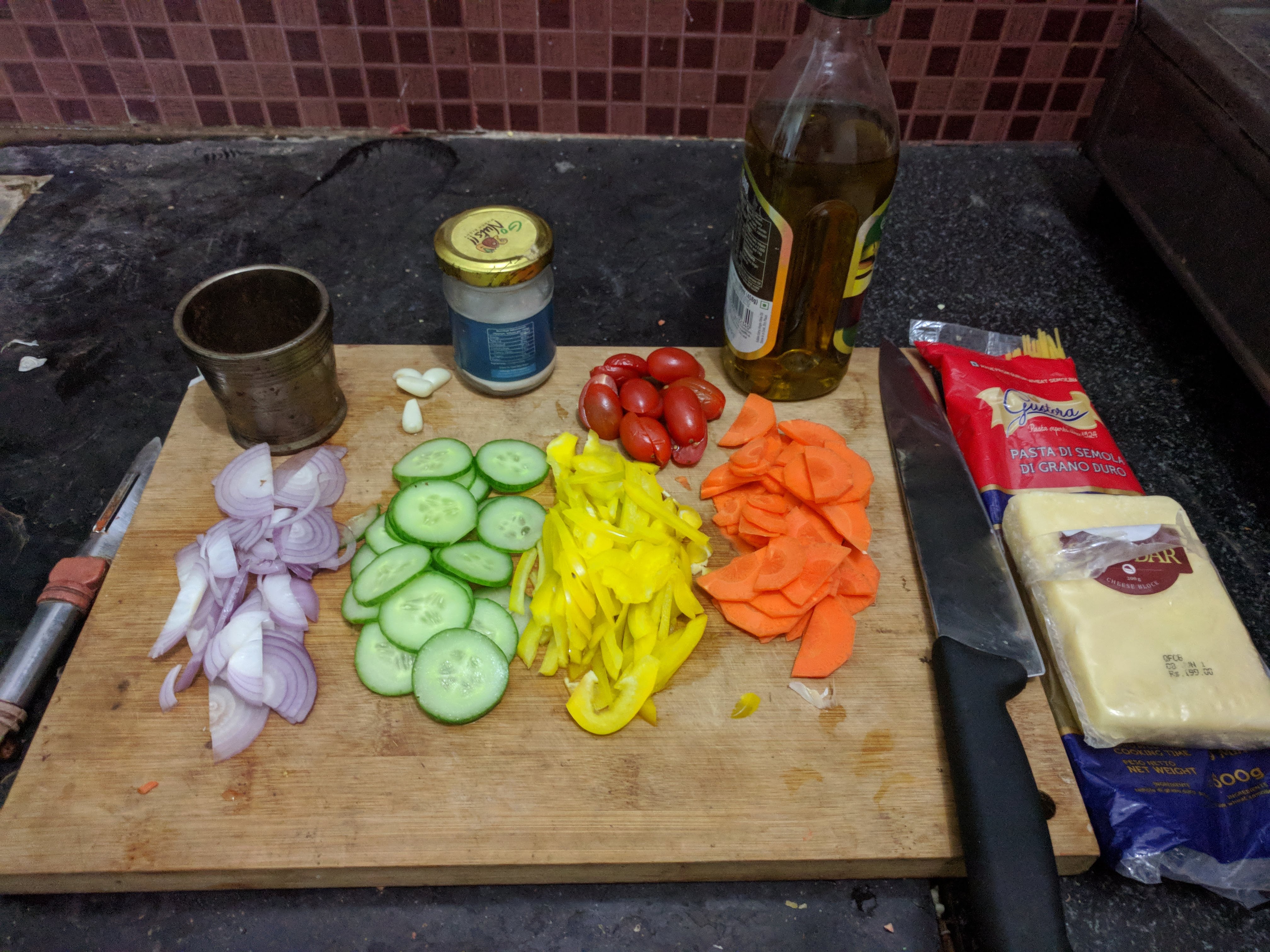 Spaghetti, cheese, 1 medium onion, 1/2 cucumber / zucchini, 1/2 bell pepper, 1/2 large carrot, few cherry tomatoes, a couple of cloves of garlic, salt, pepper (black + chilli flakes) and oil.