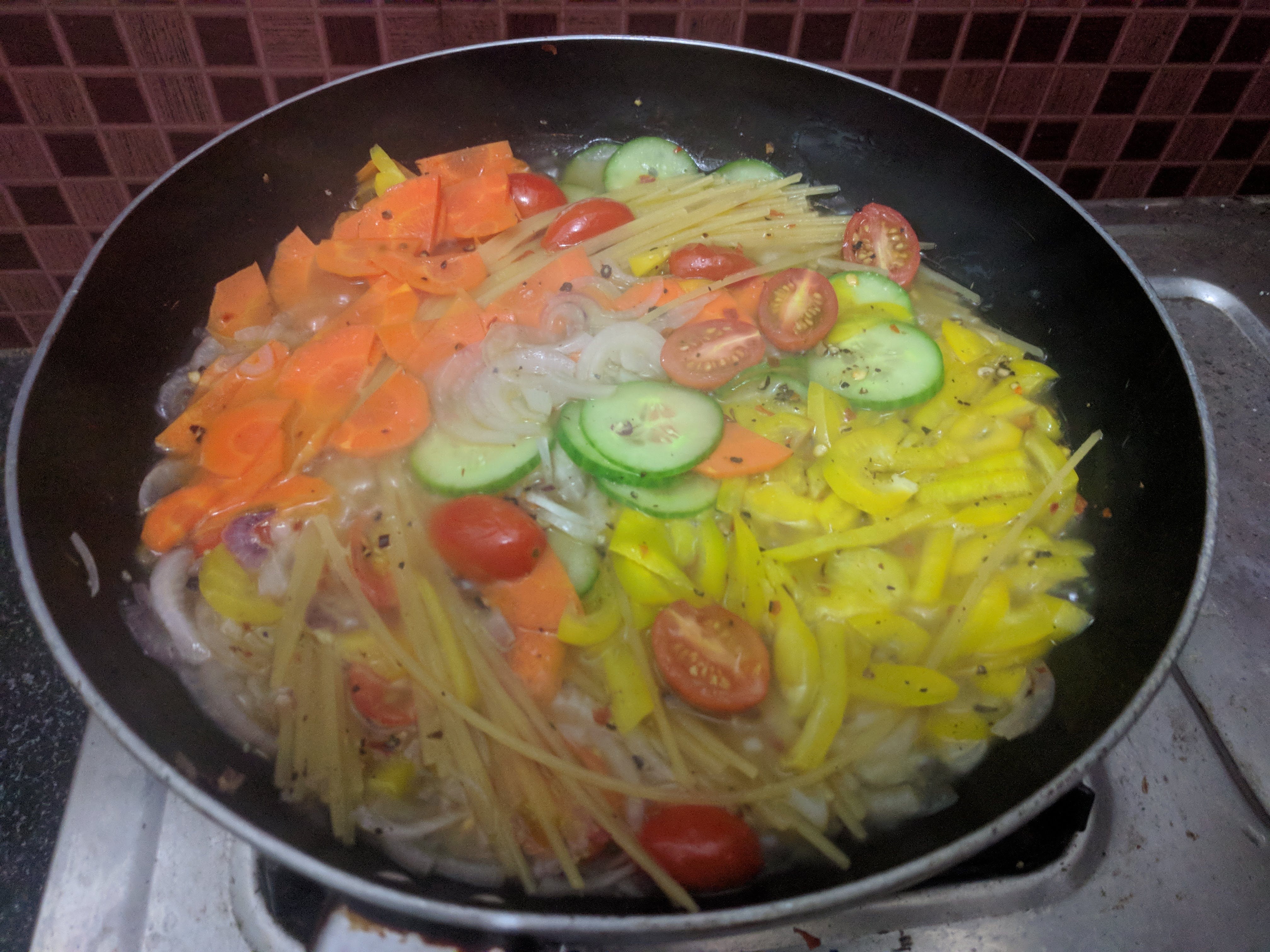 This is the state of the dish midway. I had to add half a cup of water as the water had almost dried up before the pasta was cooked.