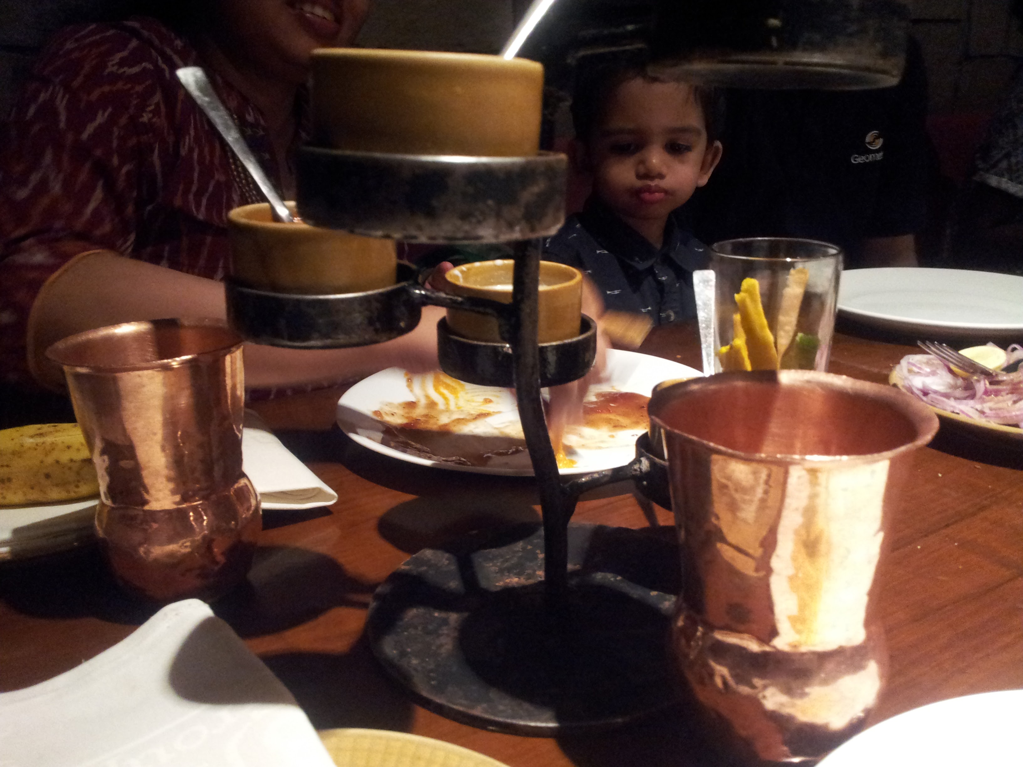 The assortment of dips placed on a decorative pedestal that plays a tree motif.