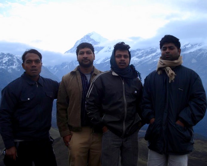 At Dzongri-La. Our smiles were obscured behind a thick fog of exhaustion just like the mountains in the background.