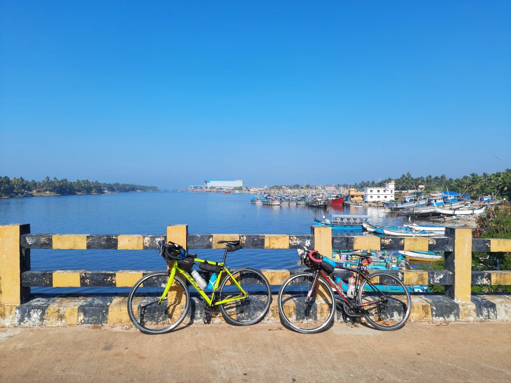 On Malpe bridge, with our cycles overlooking the harboured fishing boats.