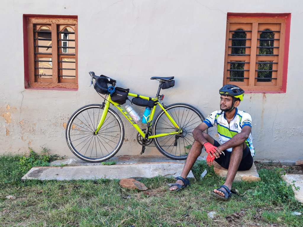 Mittal posing in front of a house on SH8.